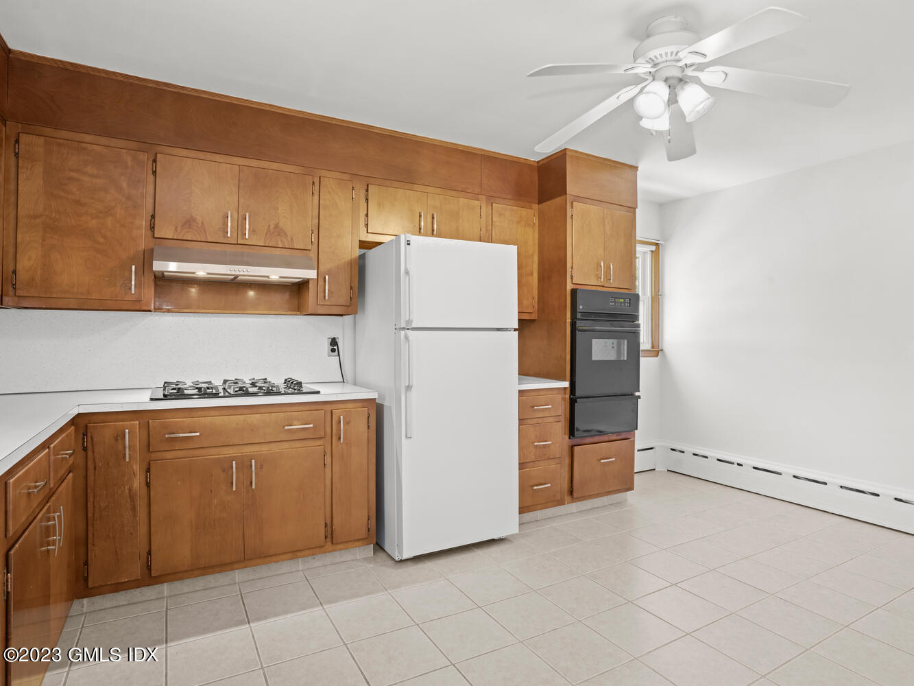 63 Cos Cob Avenue, Unit B Cos Cob, CT 06807 - Photo 3 of 14 a white refrigerator freezer and a stove sitting inside of a kitchen