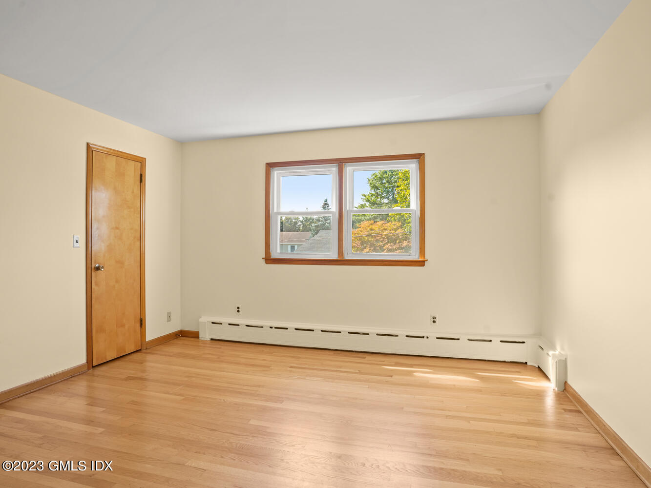 63 Cos Cob Avenue, Unit B Cos Cob, CT 06807 - Photo 6 of 14 an empty room with wooden floor and windows