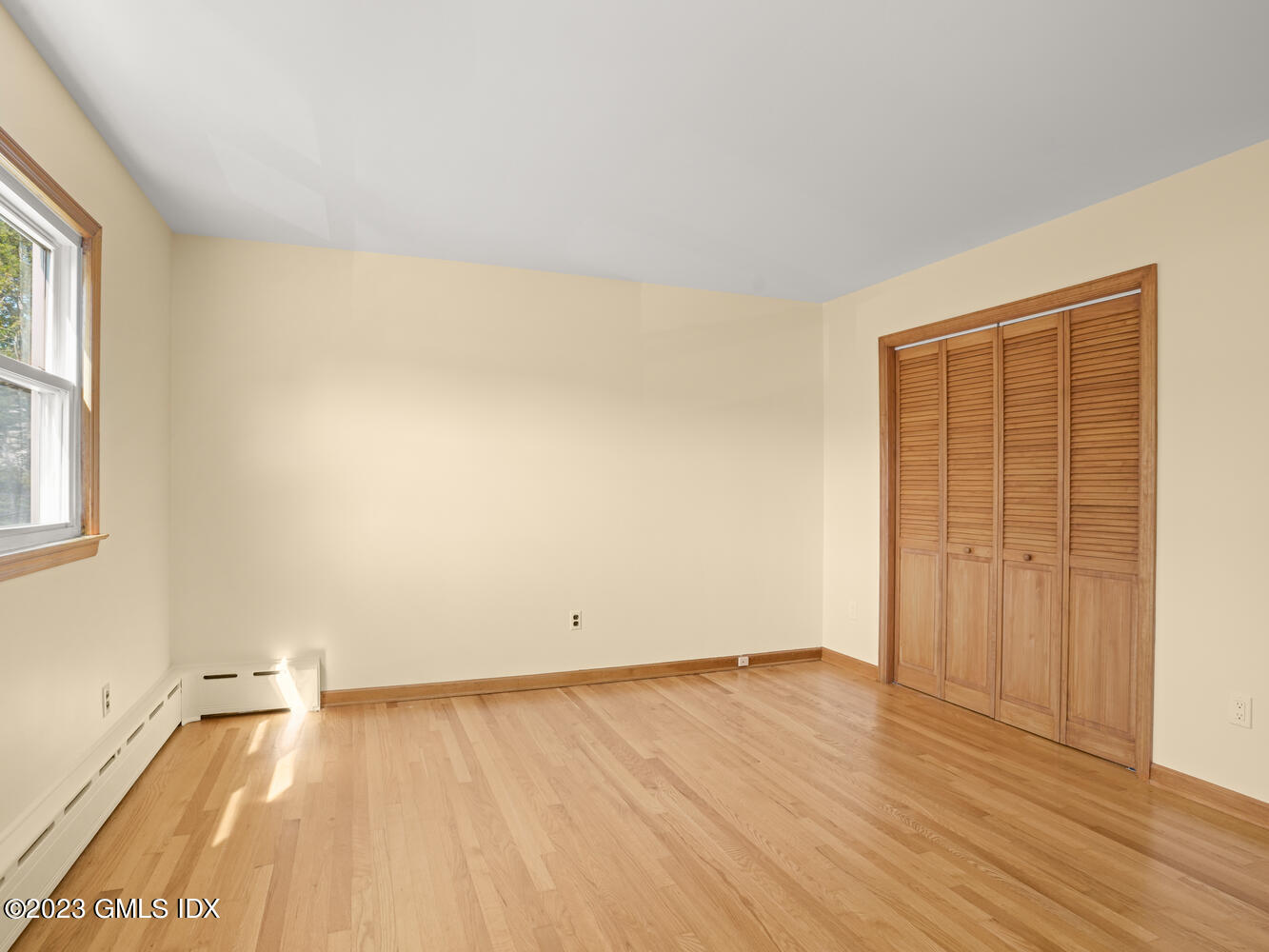 63 Cos Cob Avenue, Unit B Cos Cob, CT 06807 - Photo 7 of 14 an empty room with wooden floor and windows