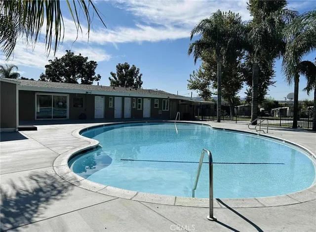 a view of a swimming pool with a lawn