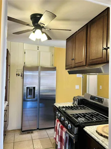 a kitchen with stainless steel appliances granite countertop a stove and a refrigerator