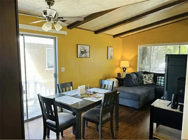 a view of a dining room with furniture and a chandelier
