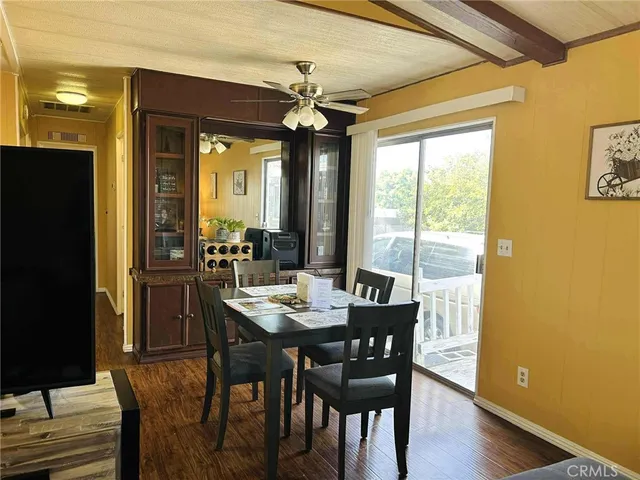 a view of a dining room with furniture wooden floor and chandelier