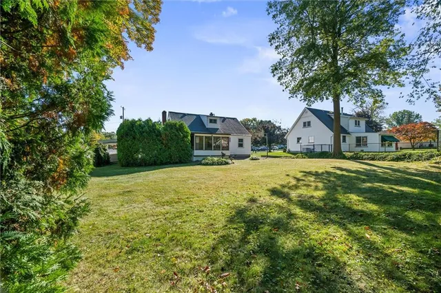 a view of backyard with a patio and a garden