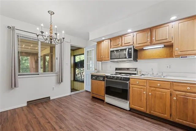 a kitchen with stainless steel appliances granite countertop a stove and cabinets
