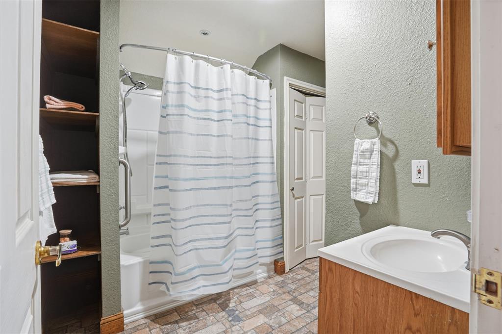 5824 Sky Road Joshua, TX 76058 - Photo 19 of 40 a bathroom with a sink and a shower
