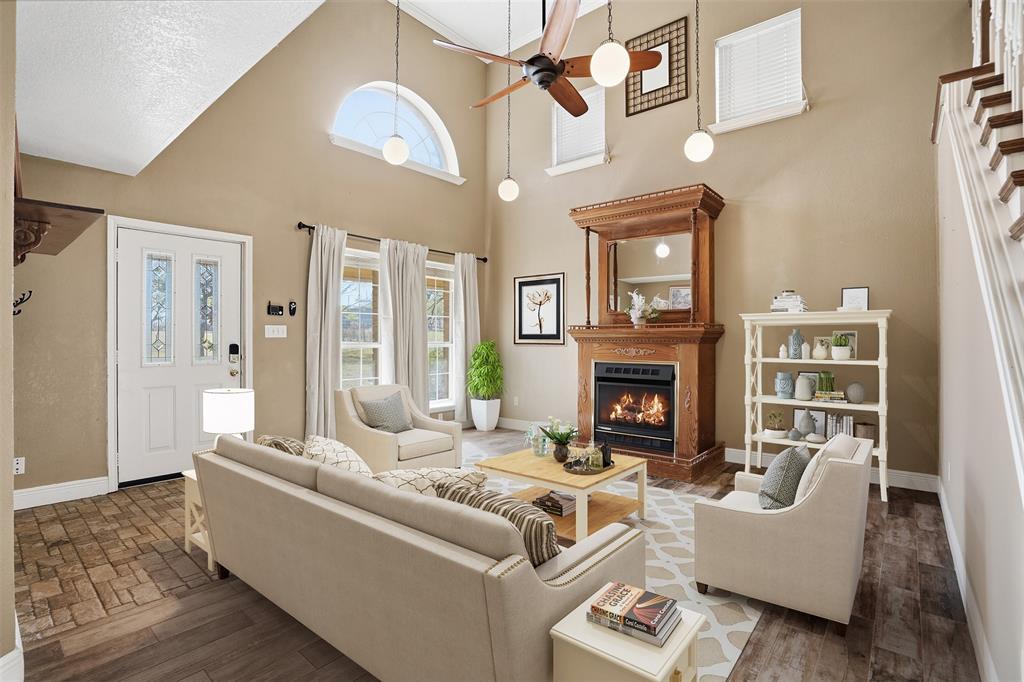 5824 Sky Road Joshua, TX 76058 - Photo 2 of 40 a living room with furniture and a fireplace