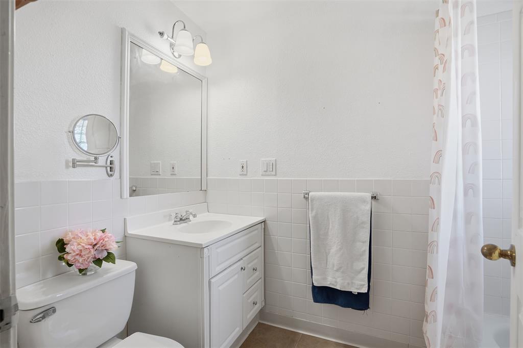 5824 Sky Road Joshua, TX 76058 - Photo 24 of 40 a bathroom with a sink vanity mirror and toilet