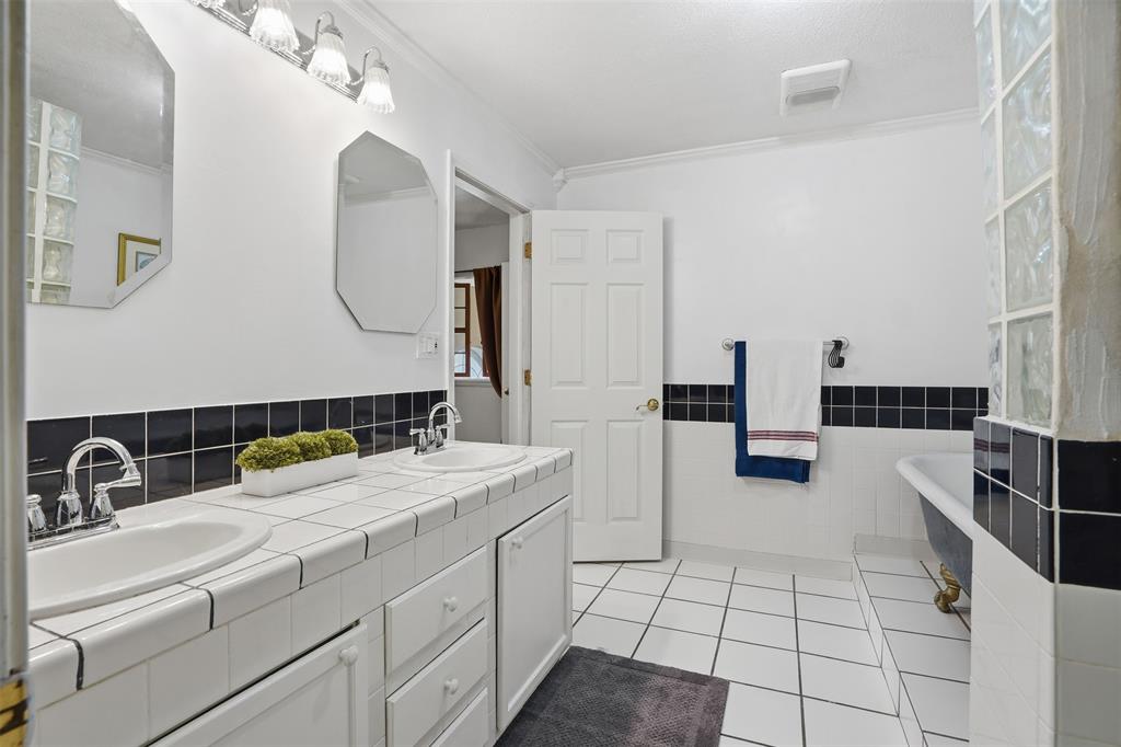 5824 Sky Road Joshua, TX 76058 - Photo 27 of 40 a bathroom with a sink and a mirror