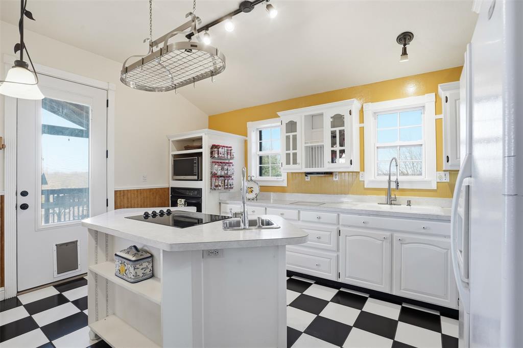 5824 Sky Road Joshua, TX 76058 - Photo 29 of 40 a kitchen with a sink appliances and cabinets