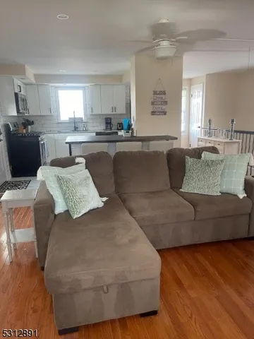 a living room with furniture and kitchen view