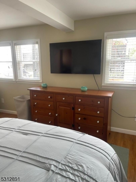 1409 River Road Belmar, NJ 07719 - Photo 17 of 22 a bedroom with a bed and a flat screen tv