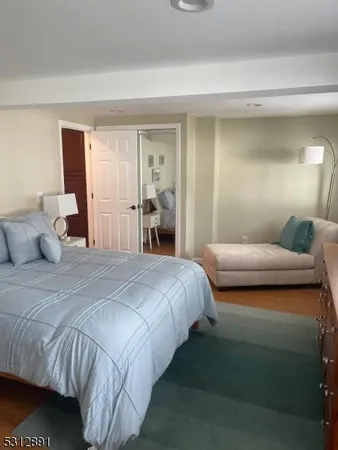 a bedroom with a bed and a mirror
