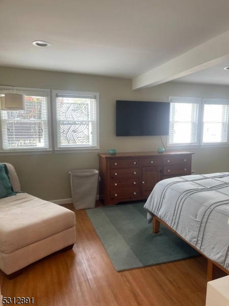 1409 River Road Belmar, NJ 07719 - Photo 20 of 22 a bedroom with a bed and a couch