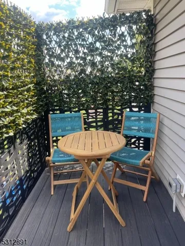 a roof deck with wooden floor and fence