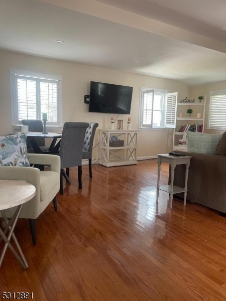 1409 River Road Belmar, NJ 07719 - Photo 4 of 22 a living room with furniture flat screen tv and wooden floor