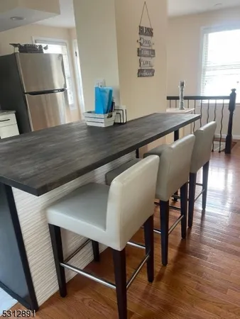a dining room with furniture and wooden floor