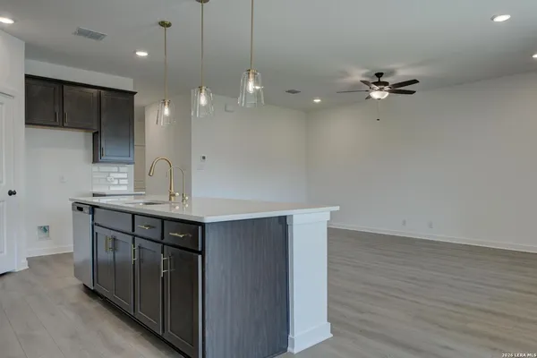 a bathroom with a sink a light fixture a vanity and a mirror