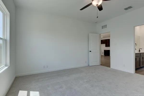 an empty room with chandelier fan