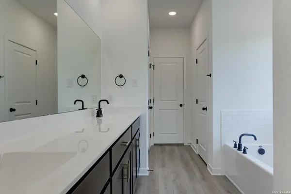 a bathroom with a bathtub and a sink