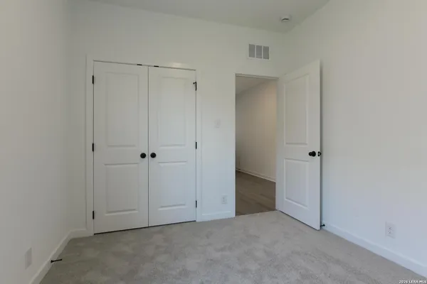 an empty room with closet area