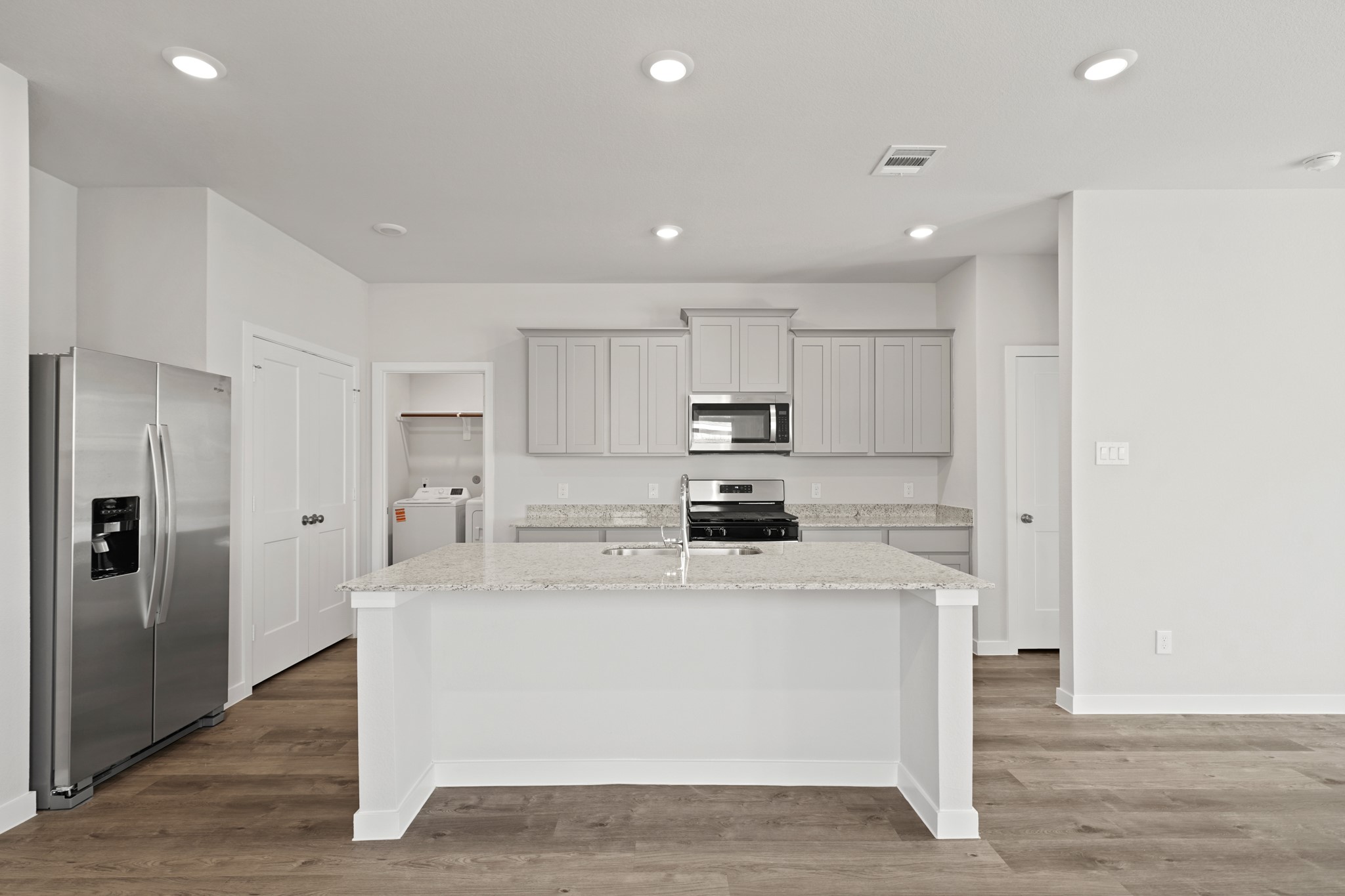 302 Amy Street Angleton, TX 77515 - Photo 15 of 27 a kitchen with stainless steel appliances a sink stove and refrigerator