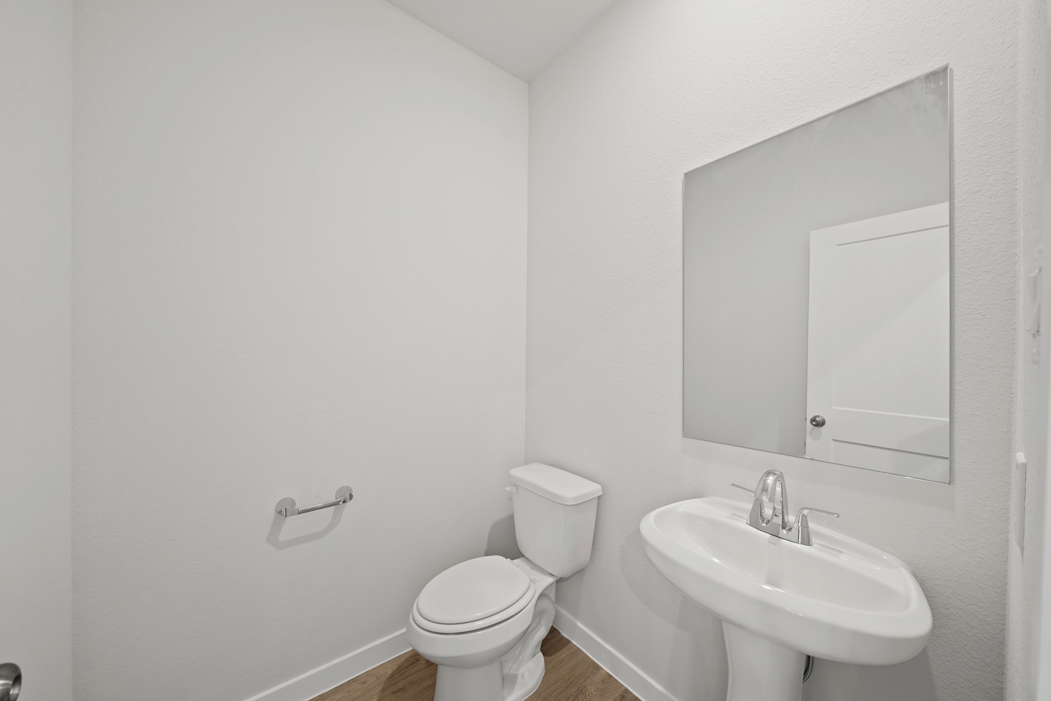 302 Amy Street Angleton, TX 77515 - Photo 4 of 27 a bathroom with a sink a toilet and a mirror