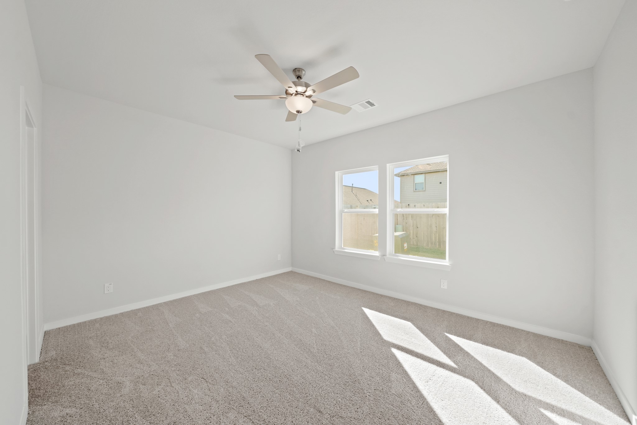 302 Amy Street Angleton, TX 77515 - Photo 6 of 27 an empty room with windows and fan