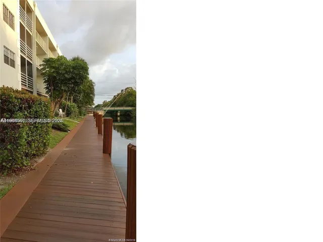 a view of a patio with couches table and chairs and potted plants