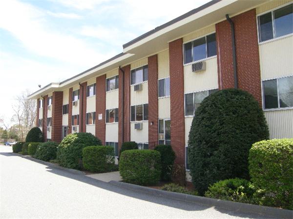 74 Beach Street, Unit 12 Woburn, MA 01801 - Photo 1 of 8 a front view of a building with garden