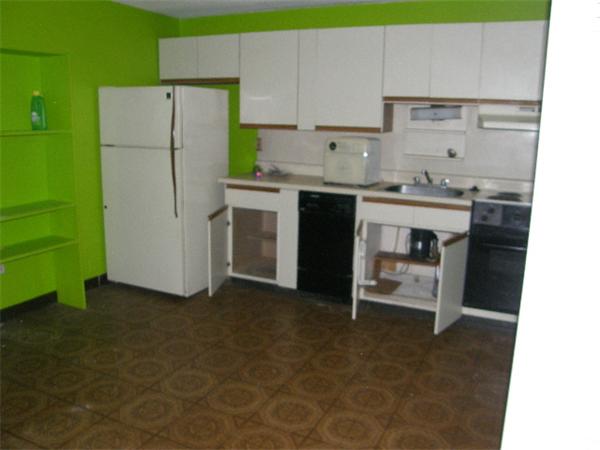 74 Beach Street, Unit 12 Woburn, MA 01801 - Photo 3 of 8 a kitchen with a sink cabinets and stainless steel appliances