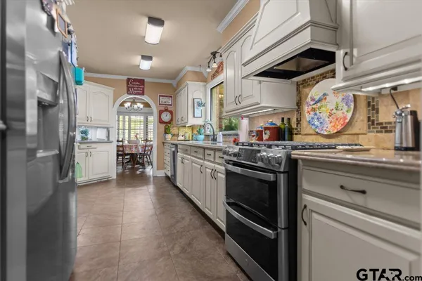 a kitchen with stainless steel appliances granite countertop a stove and cabinets