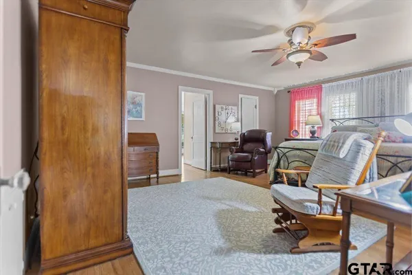 a living room with furniture a ceiling fan and a window