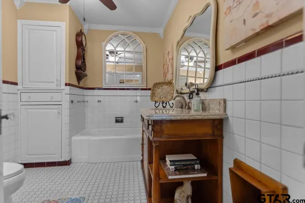 a bathroom with a sink a toilet and a mirror