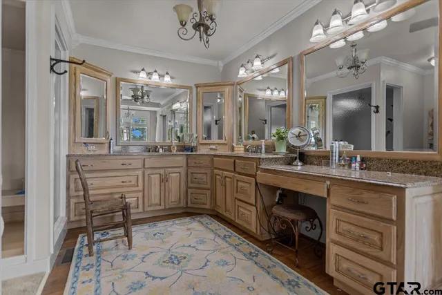 a large bathroom with a sink a vanity and a large mirror