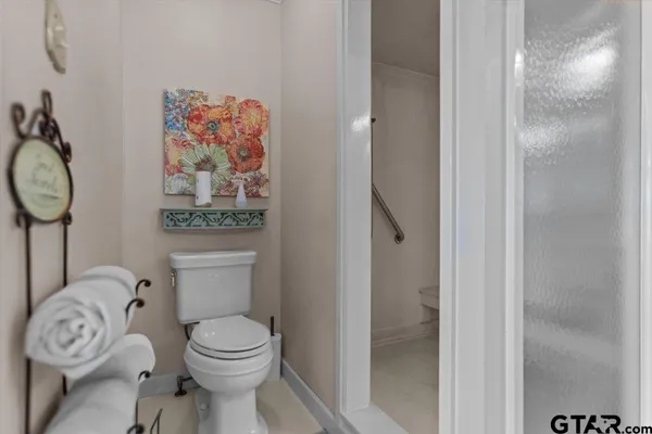 a bathroom with a toilet and a shower