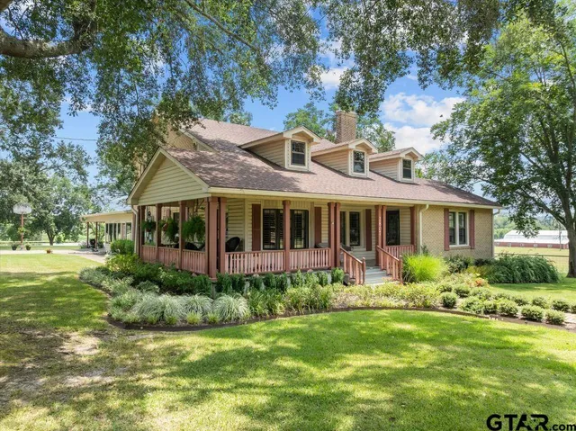 a front view of house with yard and green space