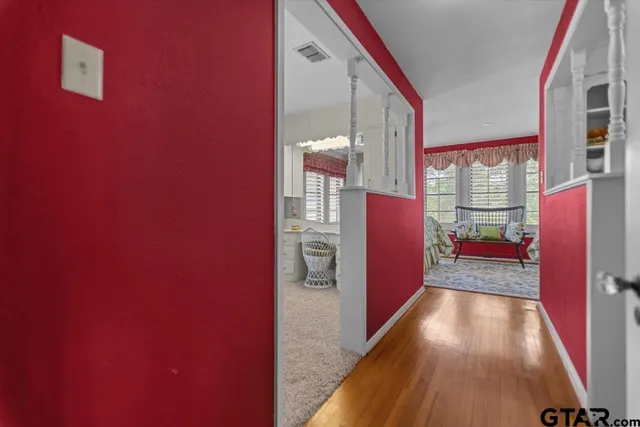 a kitchen with white cabinets and window