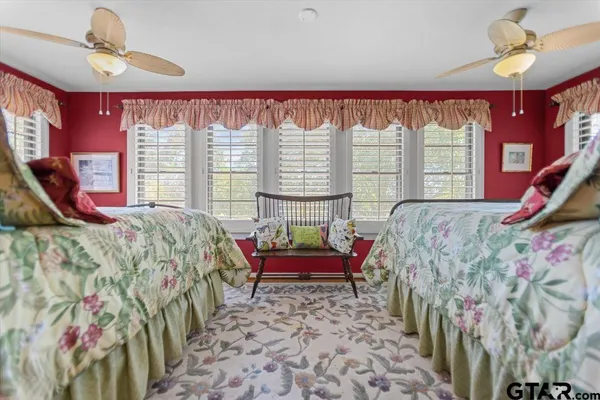 a bed sitting in a bedroom next to a window