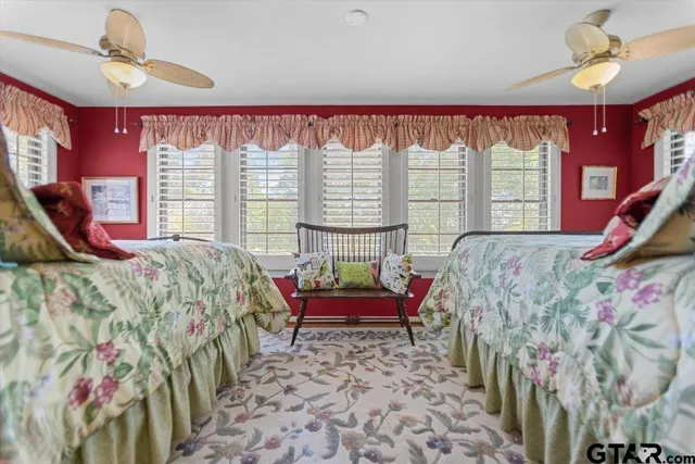 a bed sitting in a bedroom next to a window