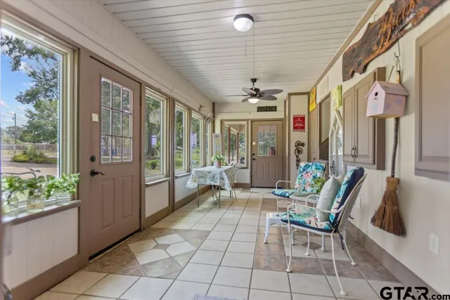 a living room with furniture and large windows
