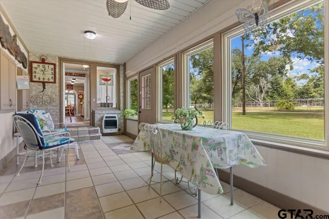 a view of a house with yard and sitting area