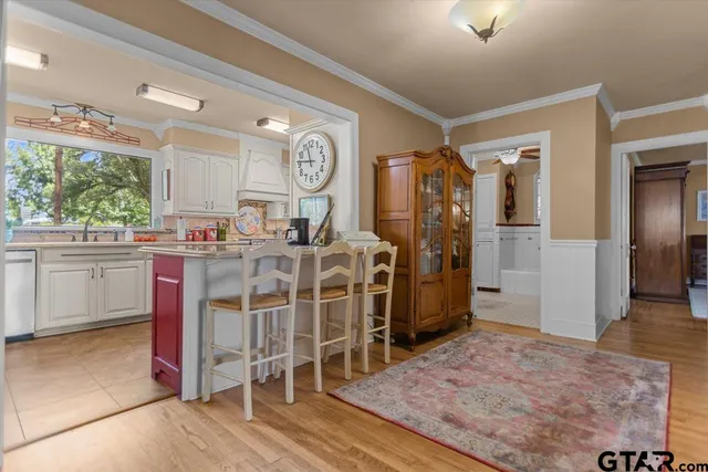 a open kitchen with granite countertop a stove top oven a sink and cabinets