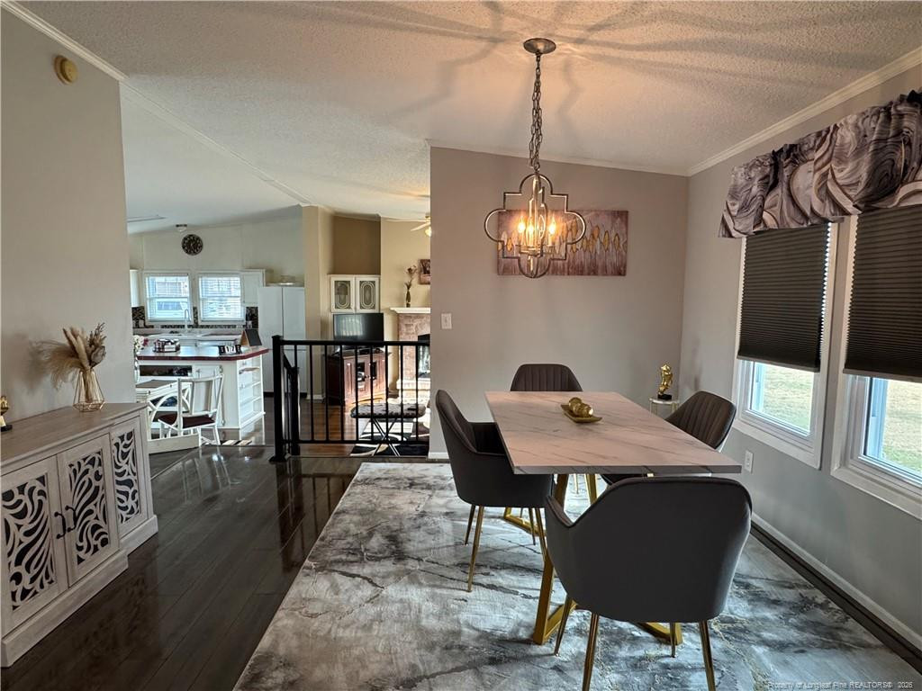 100 L Wallace McClean Road Raeford, NC 28376 - Photo 13 of 38 a view of a dining room with furniture and a chandelier