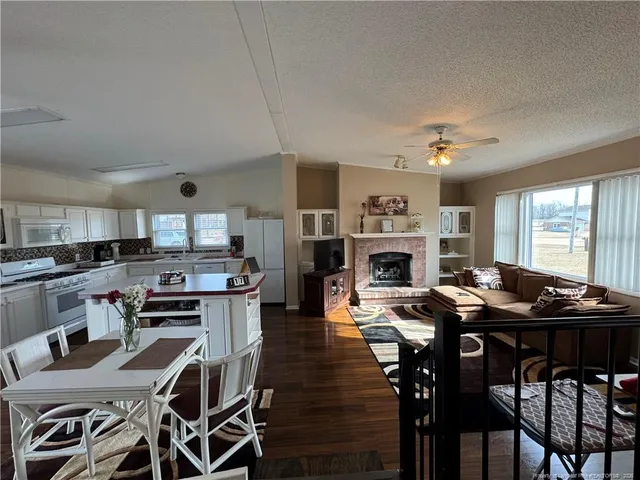 a view of a dining room with furniture and a fireplace