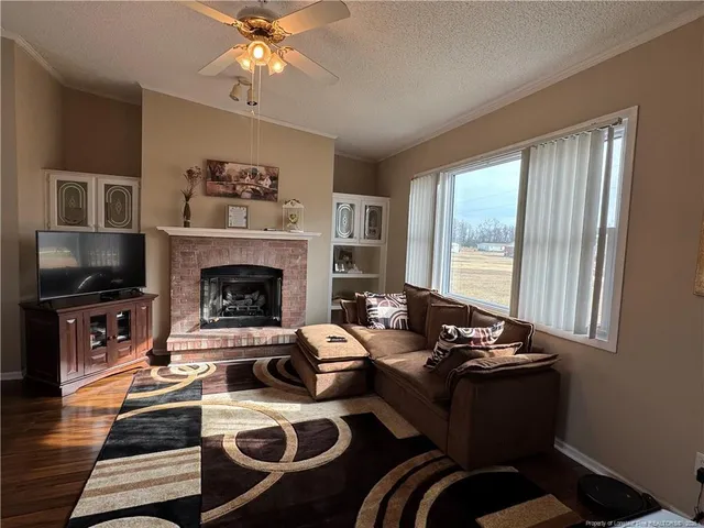a living room with furniture fireplace and flat screen tv