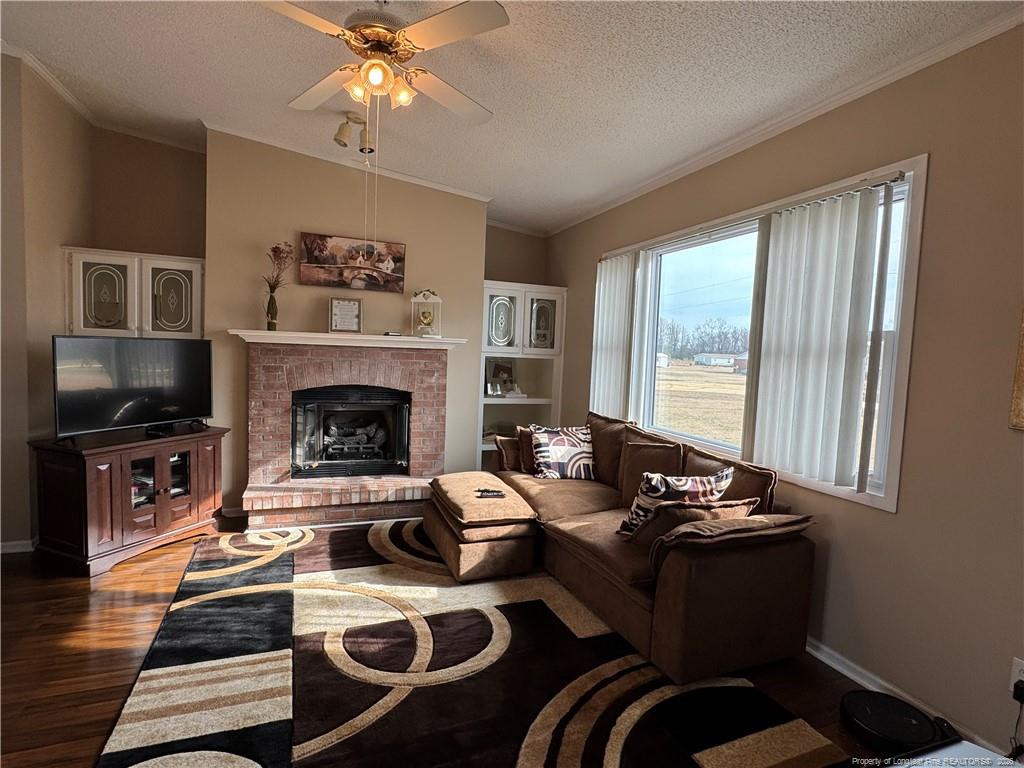 100 L Wallace McClean Road Raeford, NC 28376 - Photo 18 of 38 a living room with furniture fireplace and flat screen tv