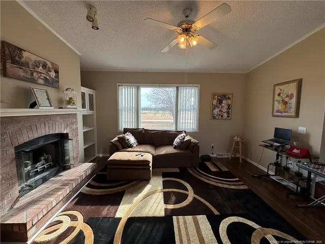 a living room with furniture fireplace and window