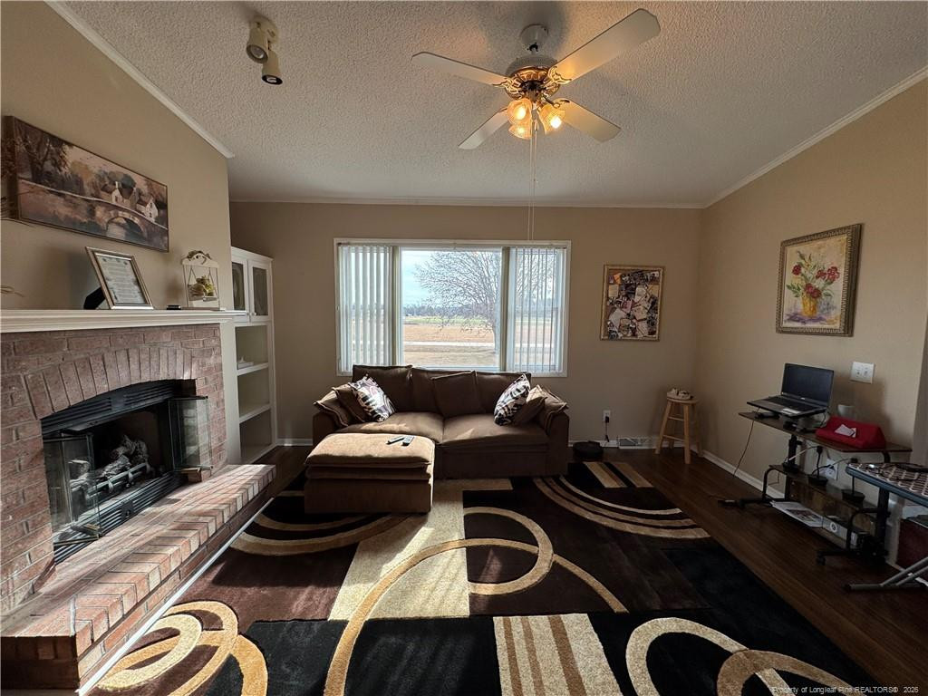 100 L Wallace McClean Road Raeford, NC 28376 - Photo 19 of 38 a living room with furniture fireplace and window