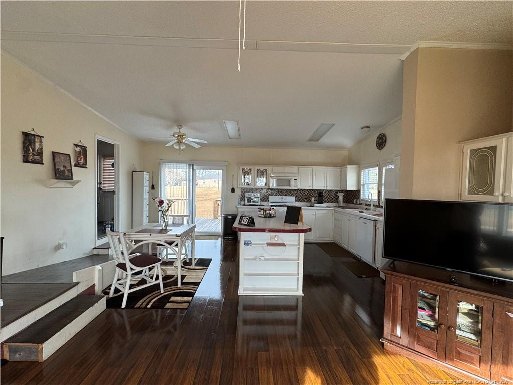 100 L Wallace McClean Road Raeford, NC 28376 - Photo 20 of 38 a living room with stainless steel appliances furniture and a flat screen tv